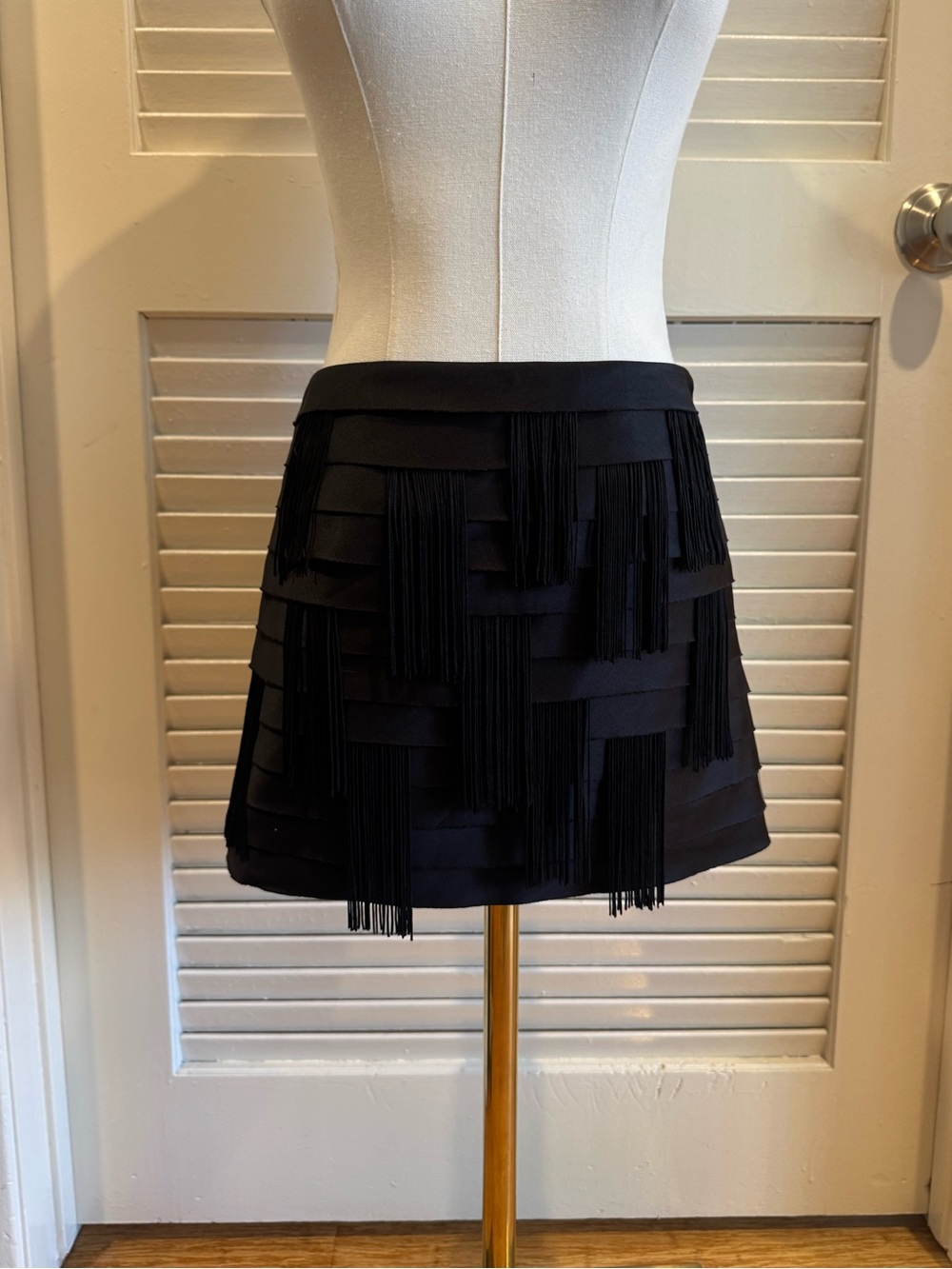 Bebe black pleated mini skirt with fringe detail